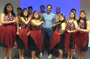 Eric Bruns with Maori high schoolers performing haka dance